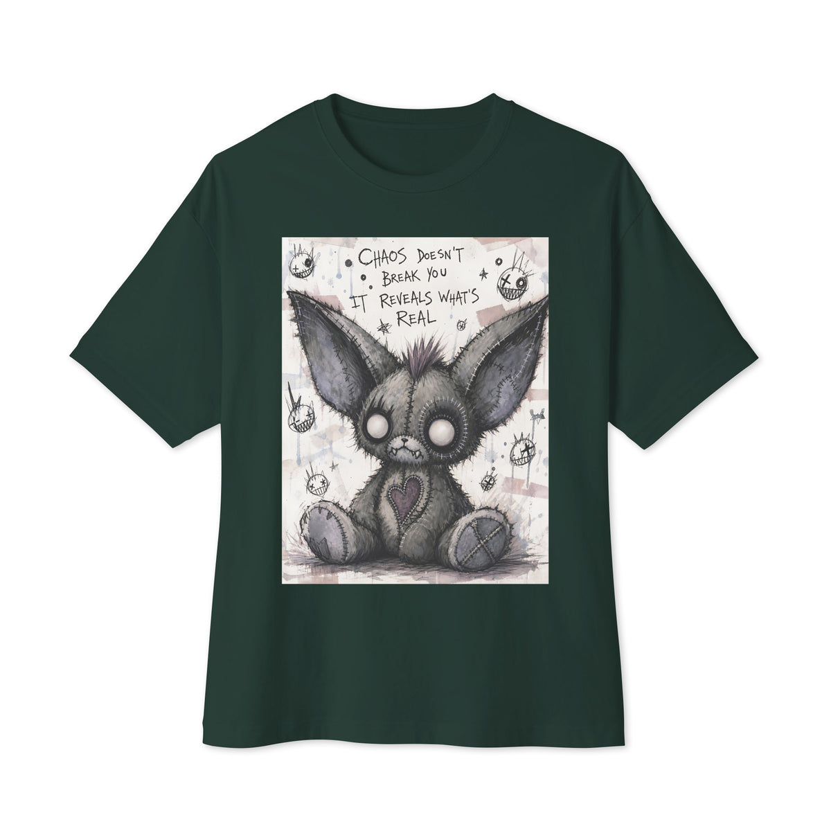 Forest oversized boxy tee with the 'Chaos' goth graphic: a stitched gray big-eared creature with button eyes, with the words "Chaos doesn't break you, it reveals what's real"