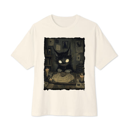 Natural oversized boxy tee with the 'Free Readings' goth graphic: a wide-eyed black cat creature at a Ouija board surrounded by candles
