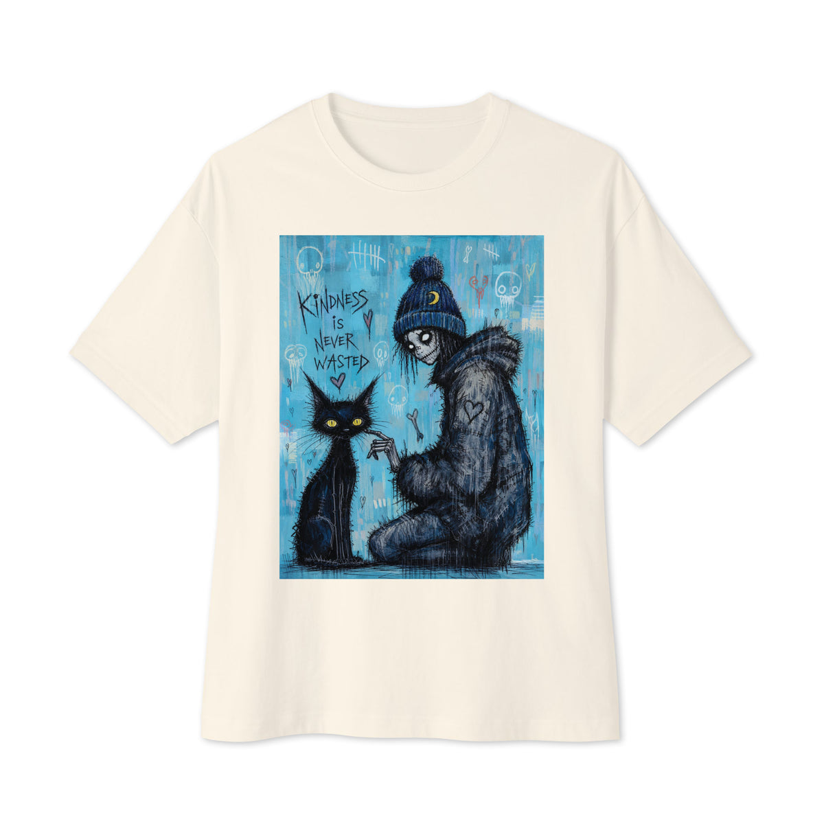 Natural oversized boxy tee with the 'Kindness Is Never Wasted' goth graphic: a girl in a moon beanie petting a black cat on a blue background, with the words "Kindness is never wasted"