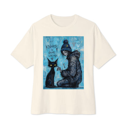 Natural oversized boxy tee with the 'Kindness Is Never Wasted' goth graphic: a girl in a moon beanie petting a black cat on a blue background, with the words "Kindness is never wasted"