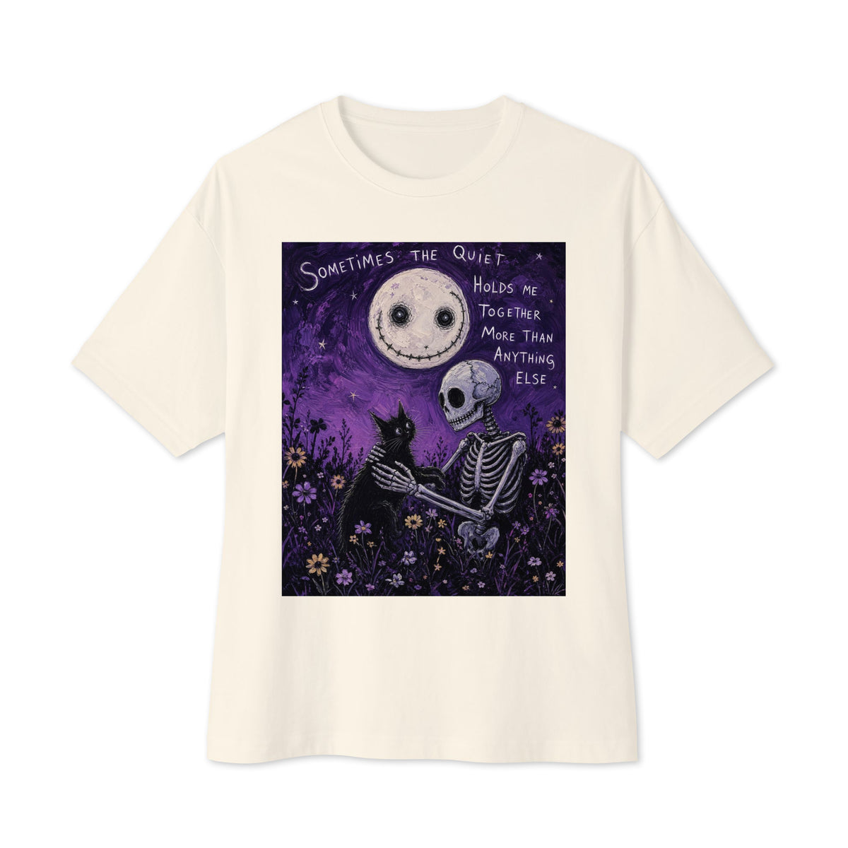 Natural oversized boxy tee with the 'The Quiet Heals' goth graphic: a skeleton and a black cat in a purple flower field under a smiling moon, with the words "Sometimes the quiet holds me together more than anything else"