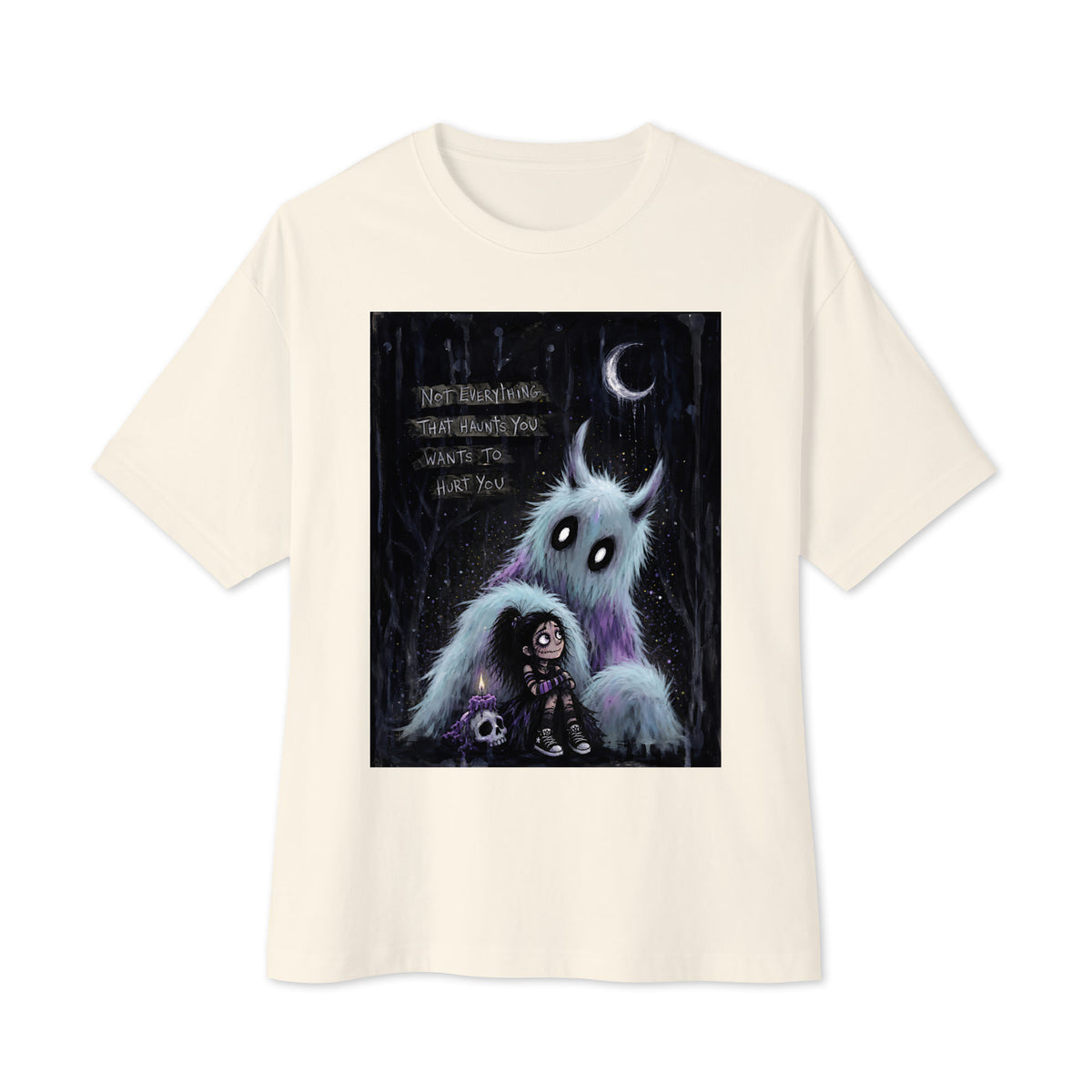 Natural oversized boxy tee with the 'The Haunted' goth graphic: a little goth girl holding a candle beside a fuzzy blue monster under a crescent moon, with the words "Not everything that haunts you wants to hurt you"