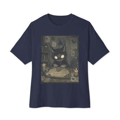 Navy oversized boxy tee with the 'Free Readings' goth graphic: a wide-eyed black cat creature at a Ouija board surrounded by candles
