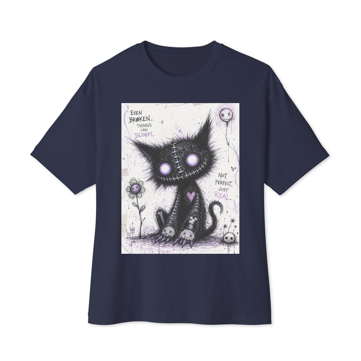 Navy oversized boxy tee with the 'Even Broken Things Can Bloom' goth graphic: a stitched black cat with glowing purple eyes beside a flower, with the words "Even broken things can bloom"