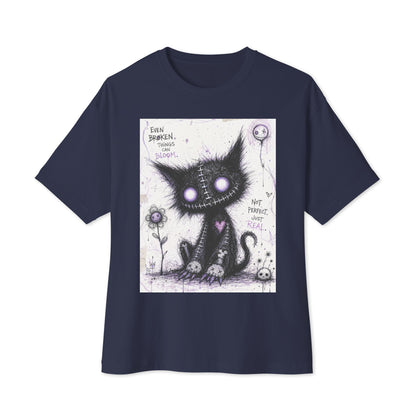 Navy oversized boxy tee with the 'Even Broken Things Can Bloom' goth graphic: a stitched black cat with glowing purple eyes beside a flower, with the words "Even broken things can bloom"