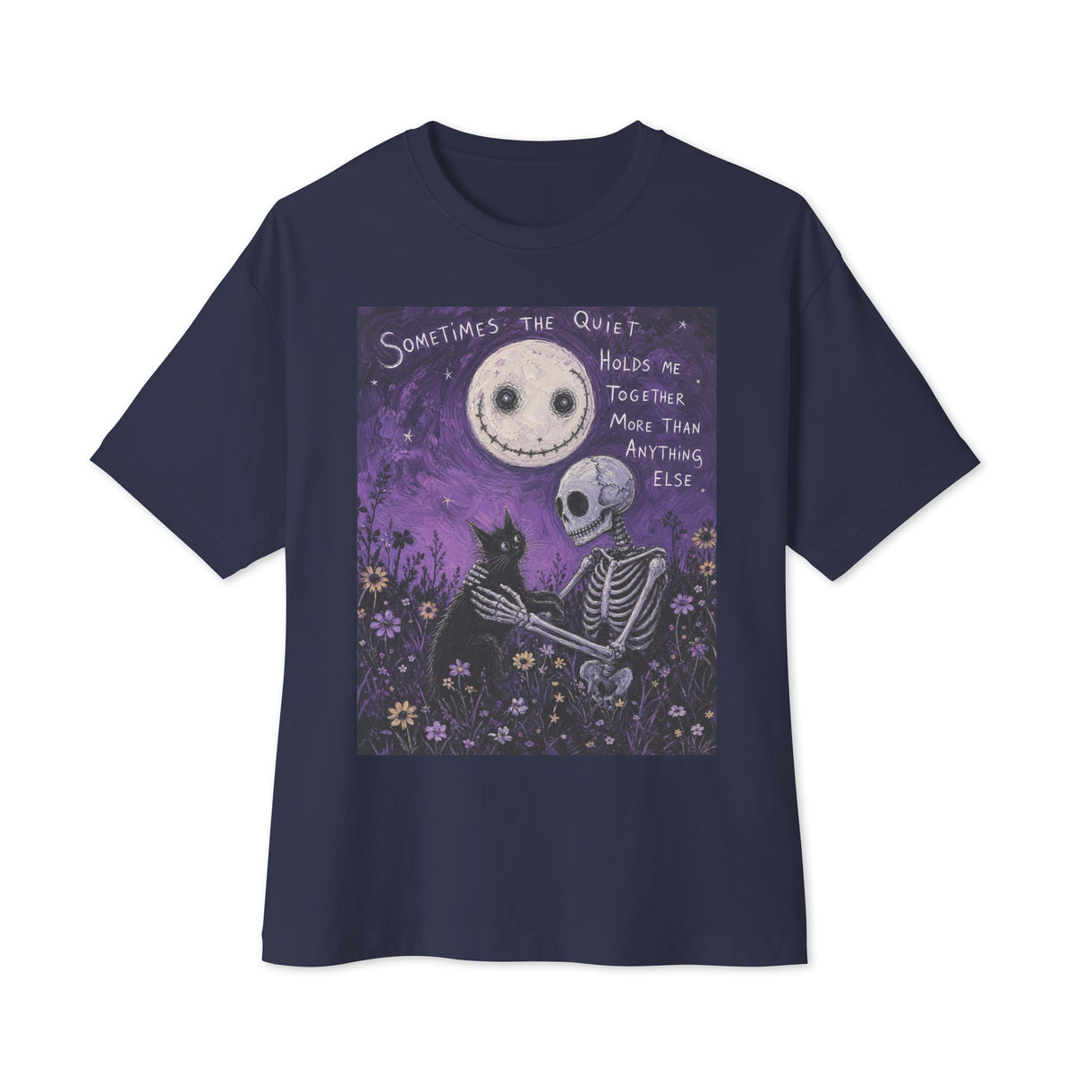 Navy oversized boxy tee with the 'The Quiet Heals' goth graphic: a skeleton and a black cat in a purple flower field under a smiling moon, with the words "Sometimes the quiet holds me together more than anything else"