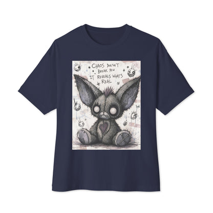 Navy oversized boxy tee with the 'Chaos' goth graphic: a stitched gray big-eared creature with button eyes, with the words "Chaos doesn't break you, it reveals what's real"