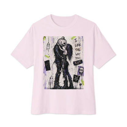 Soft pink oversized boxy tee with the 'I Like The Way You Rot' goth graphic: a pumpkin-headed zombie kissing a purple-haired goth girl, with the words "I like the way you rot"