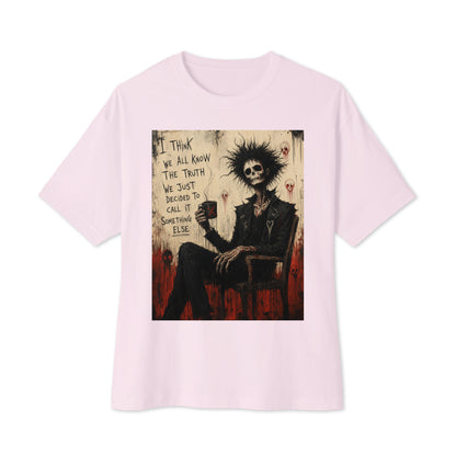 Soft pink oversized boxy tee with the 'Truth and Lies' goth graphic: a wild-haired skeleton in a chair holding a mug, with the words "I think we all know the truth, we just decided to call it something else"