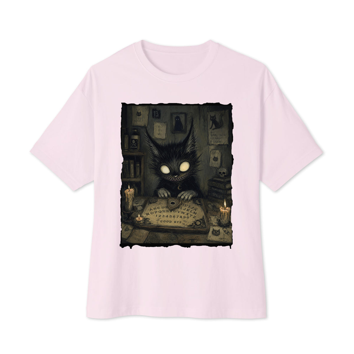 Soft pink oversized boxy tee with the 'Free Readings' goth graphic: a wide-eyed black cat creature at a Ouija board surrounded by candles