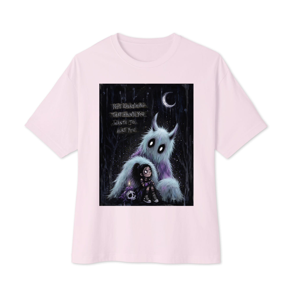 Soft pink oversized boxy tee with the 'The Haunted' goth graphic: a little goth girl holding a candle beside a fuzzy blue monster under a crescent moon, with the words "Not everything that haunts you wants to hurt you"