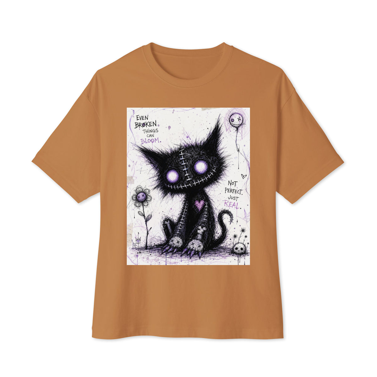 Toast oversized boxy tee with the 'Even Broken Things Can Bloom' goth graphic: a stitched black cat with glowing purple eyes beside a flower, with the words "Even broken things can bloom"