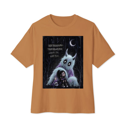Toast oversized boxy tee with the 'The Haunted' goth graphic: a little goth girl holding a candle beside a fuzzy blue monster under a crescent moon, with the words "Not everything that haunts you wants to hurt you"