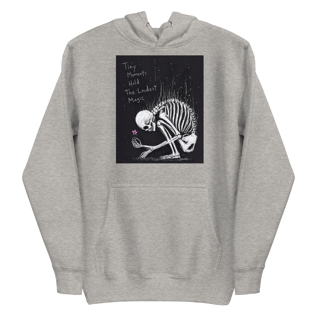 Carbon grey pullover hoodie with the 'Tiny Moments' goth graphic: a kneeling skeleton holding a tiny pink flower on a black background, with the words "Tiny moments hold the loudest magic"