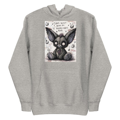 Carbon grey pullover hoodie with the 'Chaos' goth graphic: a stitched gray big-eared creature with button eyes, with the words "Chaos doesn't break you, it reveals what's real"