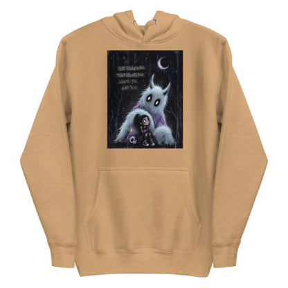 Khaki pullover hoodie with the 'The Haunted' goth graphic: a little goth girl holding a candle beside a fuzzy blue monster under a crescent moon, with the words "Not everything that haunts you wants to hurt you"