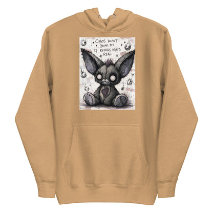 Khaki pullover hoodie with the 'Chaos' goth graphic: a stitched gray big-eared creature with button eyes, with the words "Chaos doesn't break you, it reveals what's real"