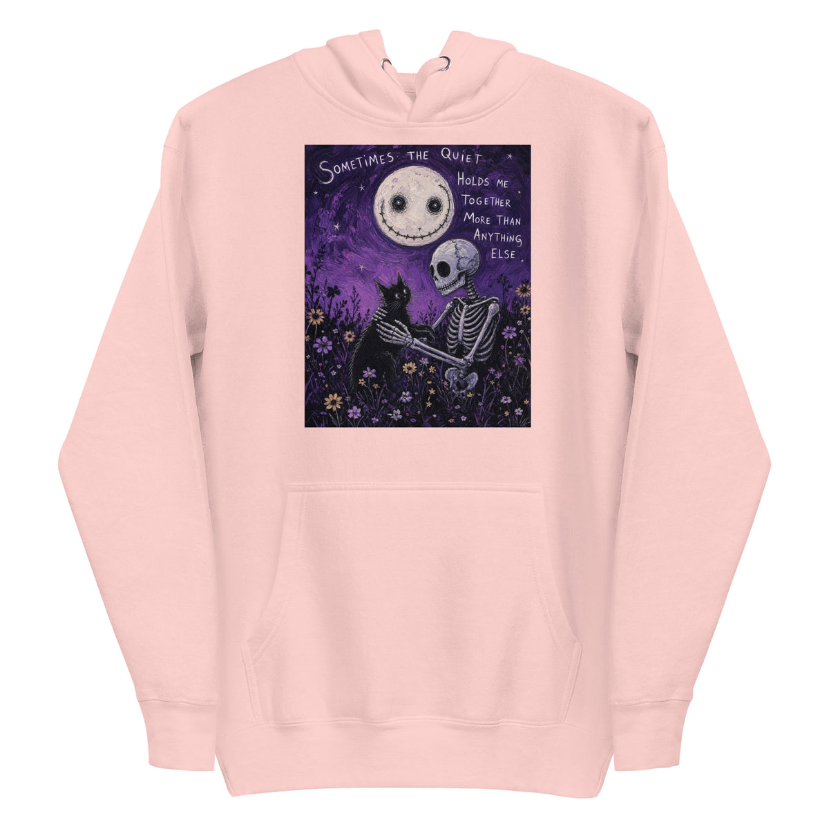 Light pink pullover hoodie with the 'The Quiet Heals' goth graphic: a skeleton and a black cat in a purple flower field under a smiling moon, with the words "Sometimes the quiet holds me together more than anything else"