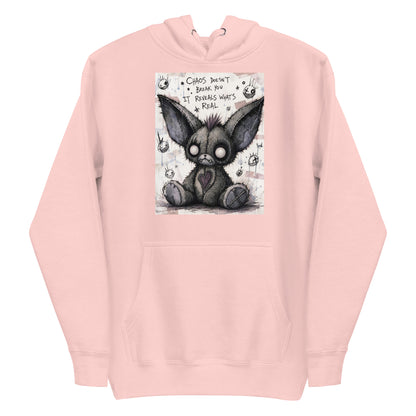 Light pink pullover hoodie with the 'Chaos' goth graphic: a stitched gray big-eared creature with button eyes, with the words "Chaos doesn't break you, it reveals what's real"