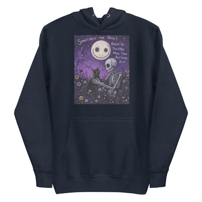 Navy pullover hoodie with the 'The Quiet Heals' goth graphic: a skeleton and a black cat in a purple flower field under a smiling moon, with the words "Sometimes the quiet holds me together more than anything else"