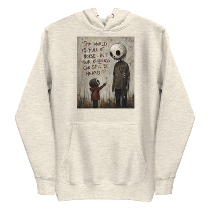 Oatmeal heather pullover hoodie with the 'Stay Kind' goth graphic: a tall skull-faced figure and a small child holding a flower, with the words "The world is full of noise, but your kindness can still be heard"