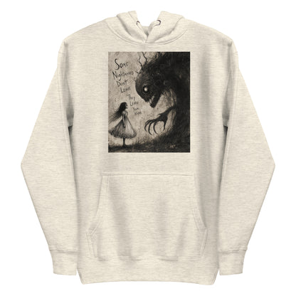 Oatmeal heather pullover hoodie with the 'Nightmares' goth graphic: a girl in a white dress facing a shadowy clawed monster, with the words "Some nightmares don't leave, they learn your name"