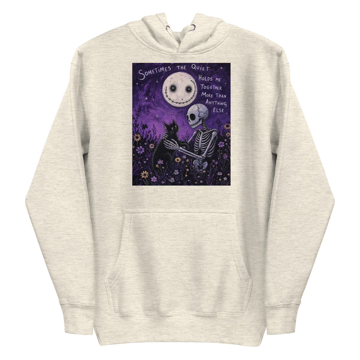 Oatmeal heather pullover hoodie with the 'The Quiet Heals' goth graphic: a skeleton and a black cat in a purple flower field under a smiling moon, with the words "Sometimes the quiet holds me together more than anything else"