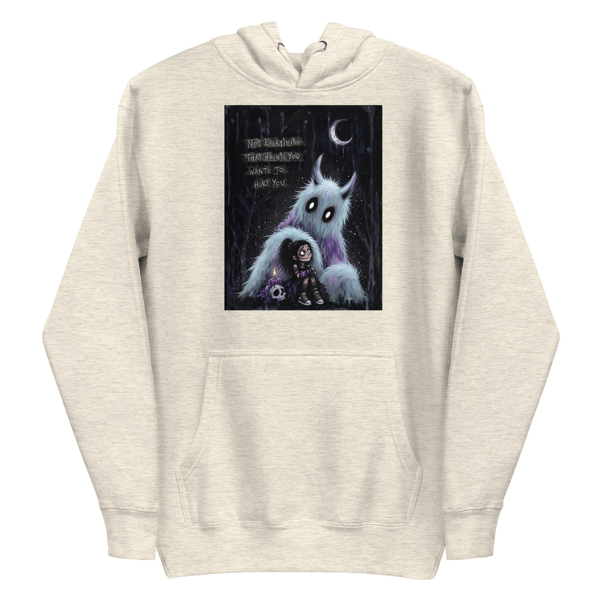 Oatmeal heather pullover hoodie with the 'The Haunted' goth graphic: a little goth girl holding a candle beside a fuzzy blue monster under a crescent moon, with the words "Not everything that haunts you wants to hurt you"