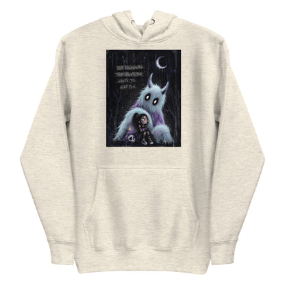 Oatmeal heather pullover hoodie with the 'The Haunted' goth graphic: a little goth girl holding a candle beside a fuzzy blue monster under a crescent moon, with the words "Not everything that haunts you wants to hurt you"