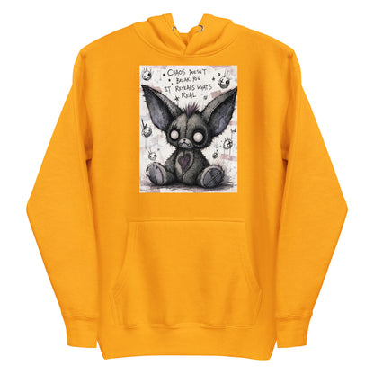Gold pullover hoodie with the 'Chaos' goth graphic: a stitched gray big-eared creature with button eyes, with the words "Chaos doesn't break you, it reveals what's real"