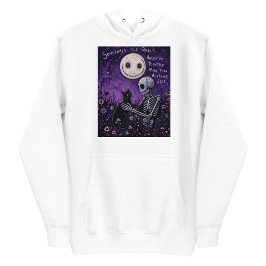 White pullover hoodie with the 'The Quiet Heals' goth graphic: a skeleton and a black cat in a purple flower field under a smiling moon, with the words "Sometimes the quiet holds me together more than anything else"