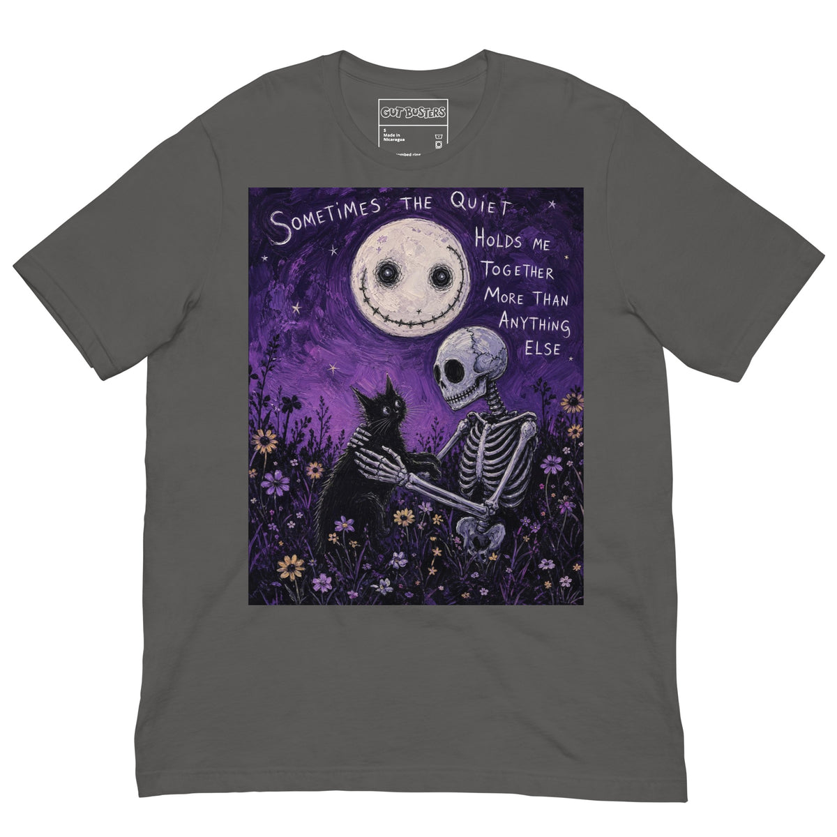Asphalt unisex t-shirt with the 'The Quiet Heals' goth graphic: a skeleton and a black cat in a purple flower field under a smiling moon, with the words "Sometimes the quiet holds me together more than anything else"