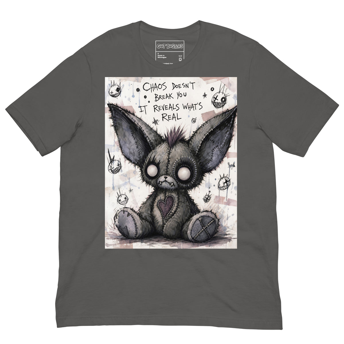 Asphalt unisex t-shirt with the 'Chaos' goth graphic: a stitched gray big-eared creature with button eyes, with the words "Chaos doesn't break you, it reveals what's real"
