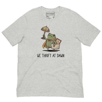 Funny "We Thrift At Dawn Frog" graphic printed on an athletic heather unisex tee, front view