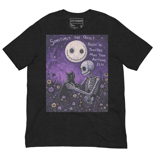 Black heather unisex t-shirt with the 'The Quiet Heals' goth graphic: a skeleton and a black cat in a purple flower field under a smiling moon, with the words "Sometimes the quiet holds me together more than anything else"