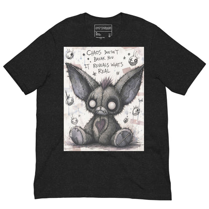 Black heather unisex t-shirt with the 'Chaos' goth graphic: a stitched gray big-eared creature with button eyes, with the words "Chaos doesn't break you, it reveals what's real"
