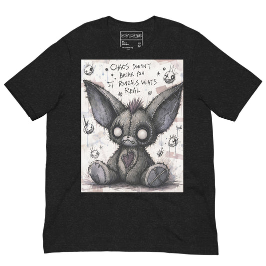 Black heather unisex t-shirt with the 'Chaos' goth graphic: a stitched gray big-eared creature with button eyes, with the words "Chaos doesn't break you, it reveals what's real"