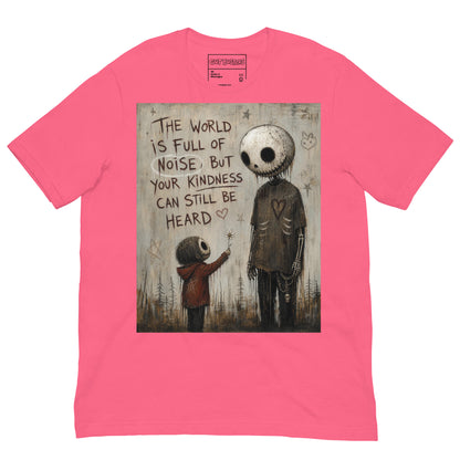 Pink unisex t-shirt with the 'Stay Kind' goth graphic: a tall skull-faced figure and a small child holding a flower, with the words "The world is full of noise, but your kindness can still be heard"