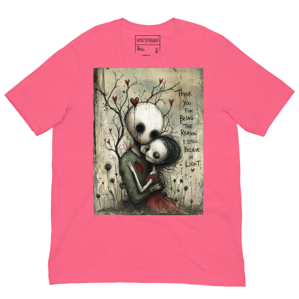 Pink unisex t-shirt with the 'My Light In Dark Places' goth graphic: a skull-faced couple embracing under a bare tree with red hearts, with the words "Thank you for being the reason I still believe in light"