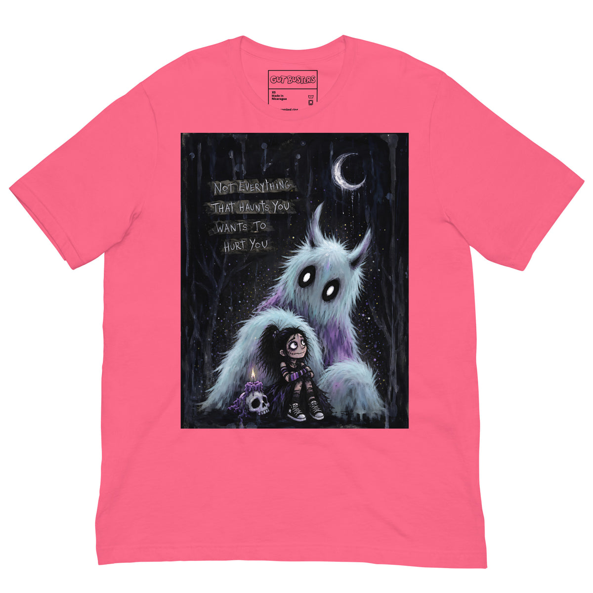 Pink unisex t-shirt with the 'The Haunted' goth graphic: a little goth girl holding a candle beside a fuzzy blue monster under a crescent moon, with the words "Not everything that haunts you wants to hurt you"