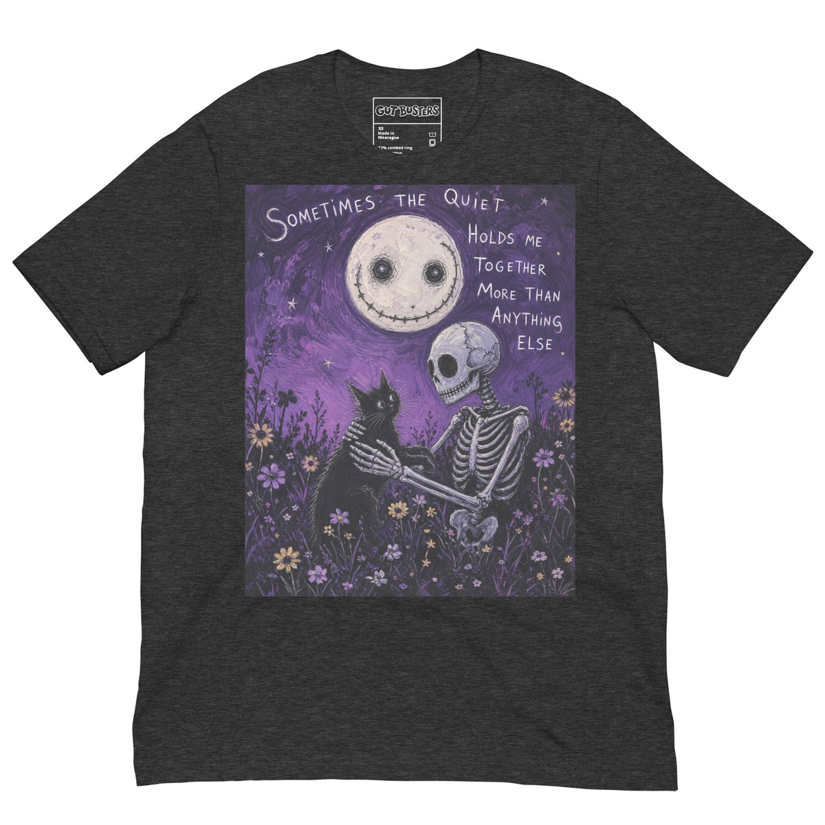 Dark grey heather unisex t-shirt with the 'The Quiet Heals' goth graphic: a skeleton and a black cat in a purple flower field under a smiling moon, with the words "Sometimes the quiet holds me together more than anything else"