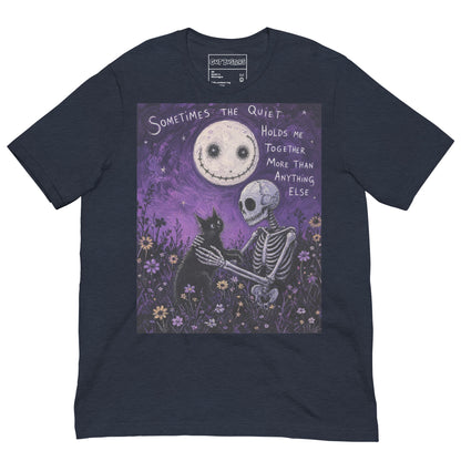 Heather navy unisex t-shirt with the 'The Quiet Heals' goth graphic: a skeleton and a black cat in a purple flower field under a smiling moon, with the words "Sometimes the quiet holds me together more than anything else"
