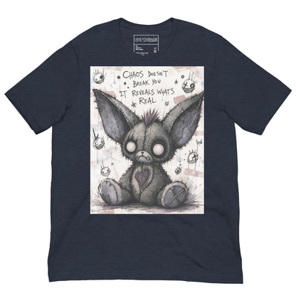 Heather navy unisex t-shirt with the 'Chaos' goth graphic: a stitched gray big-eared creature with button eyes, with the words "Chaos doesn't break you, it reveals what's real"