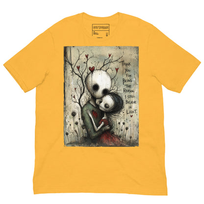 Heather yellow unisex t-shirt with the 'My Light In Dark Places' goth graphic: a skull-faced couple embracing under a bare tree with red hearts, with the words "Thank you for being the reason I still believe in light"