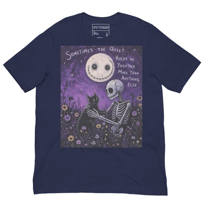 Navy unisex t-shirt with the 'The Quiet Heals' goth graphic: a skeleton and a black cat in a purple flower field under a smiling moon, with the words "Sometimes the quiet holds me together more than anything else"