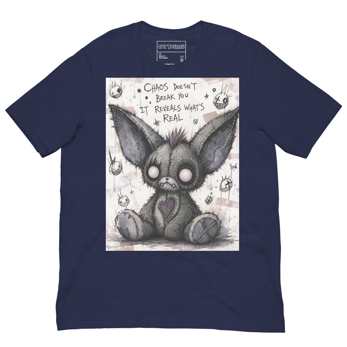 Navy unisex t-shirt with the 'Chaos' goth graphic: a stitched gray big-eared creature with button eyes, with the words "Chaos doesn't break you, it reveals what's real"