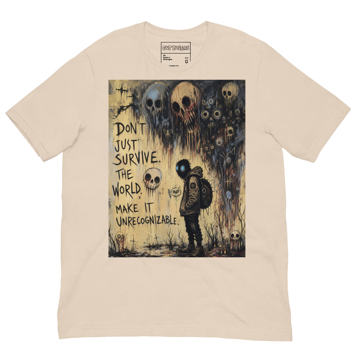 Soft cream unisex t-shirt with the 'World Changer' goth graphic: a hooded figure beneath looming skulls, with the words "Don't just survive the world, make it unrecognizable"