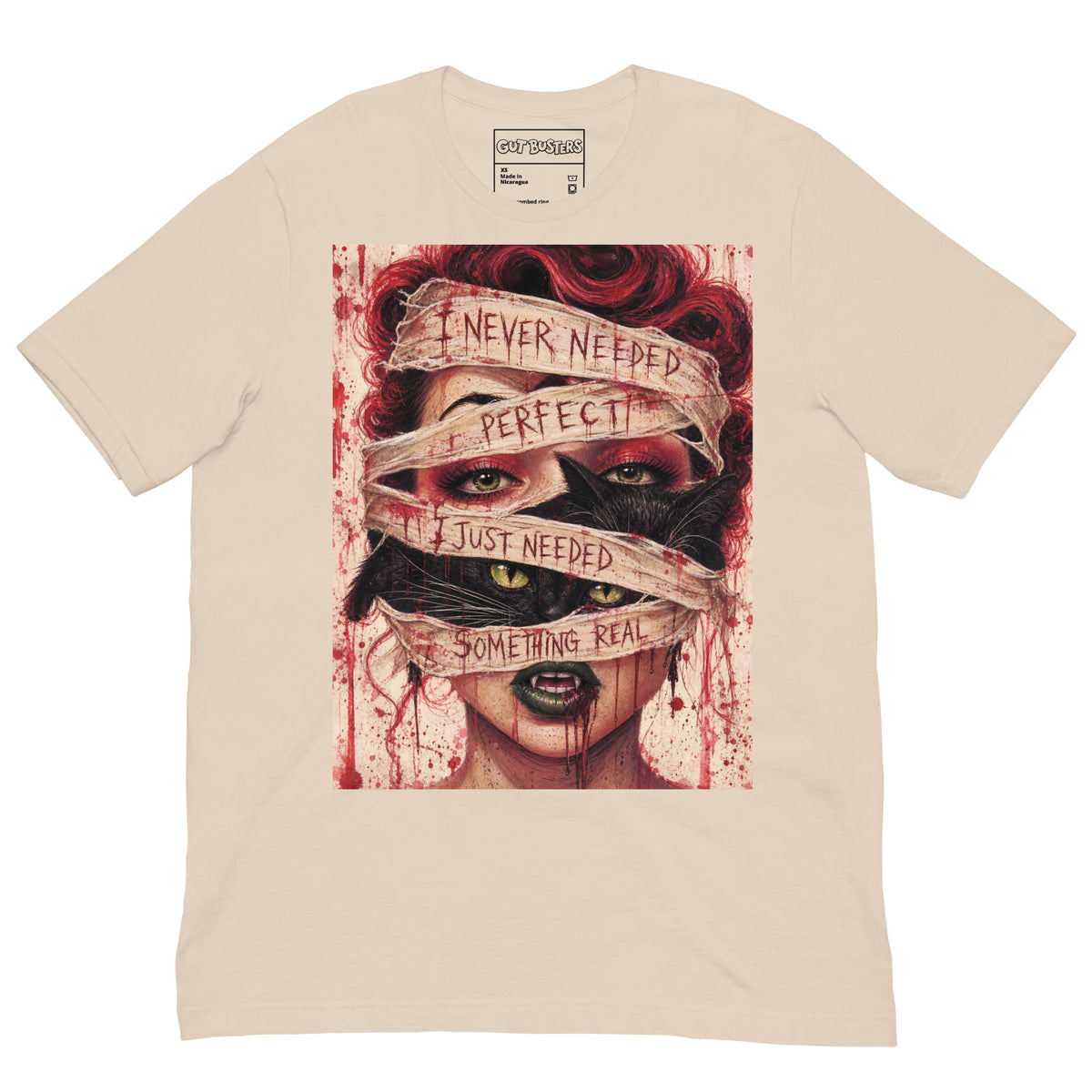 Soft cream unisex t-shirt with the 'Just Something Real' goth graphic: a red-haired woman's face wrapped in bandages, with the words "I never needed perfect, I just needed something real"