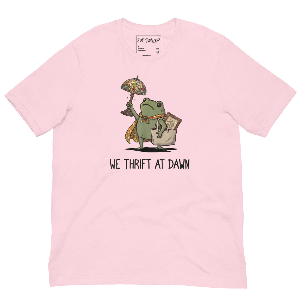 Funny "We Thrift At Dawn Frog" graphic printed on a soft pink unisex tee, front view