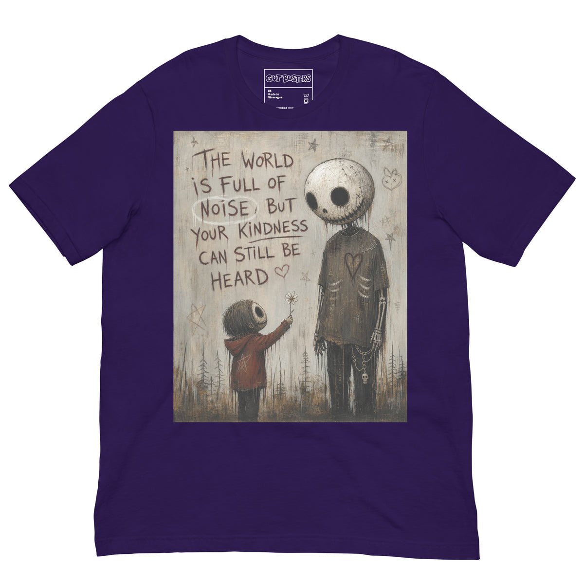 Purple unisex t-shirt with the 'Stay Kind' goth graphic: a tall skull-faced figure and a small child holding a flower, with the words "The world is full of noise, but your kindness can still be heard"